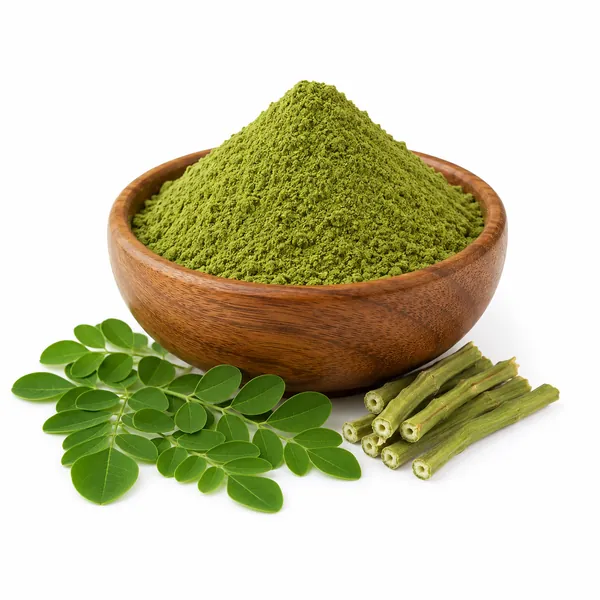 Moringa (Moringa oleifera) leaf powder in a wooden bowl with fresh leaves and drumstick pods — VKRUND ENTERPRISE, bulk supplier & exporter from India